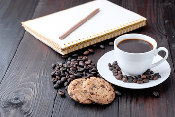 Coffee cup and coffee beans on wooden background