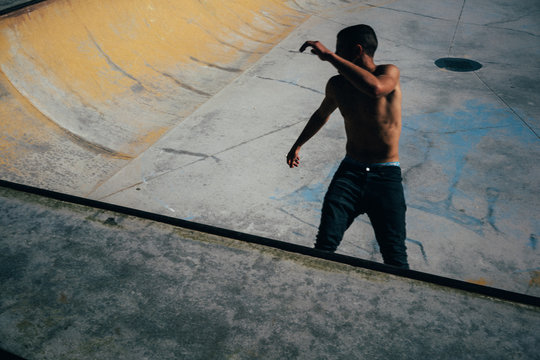 skateboarder in skatepark bowl
