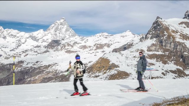 Time lapse, with young skiers, in the background of the Alps ahead of the Matterhorn