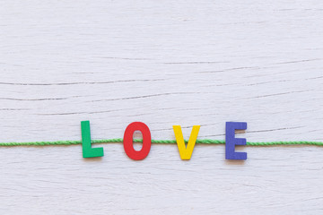 Colorful wooden alphabet and LOVE word on white wooden