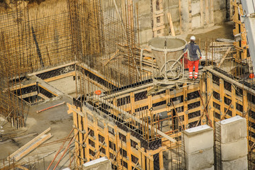 Tower crane bucket full of concrete liquid