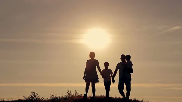 Family at sunset, silhouettes.