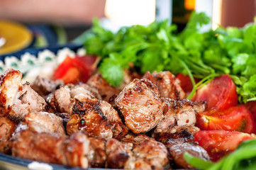 skewers roasted over an open fire, lying on a plate with herbs, selective focus