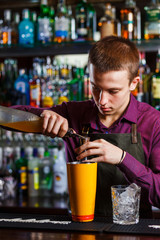 The bartender making cocktail