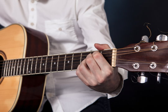 man playing classical guitar close up isolated