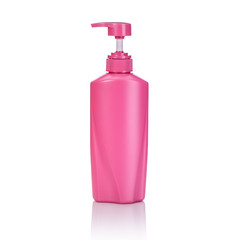 Blank pink plastic pump bottle used for shampoo or soap. Studio shot isolated on white