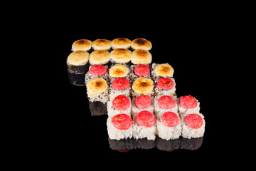 A set of sushi on black isolate with reflection. Concept of Asia
