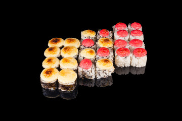 A set of sushi on black isolate with reflection. Concept of Asia