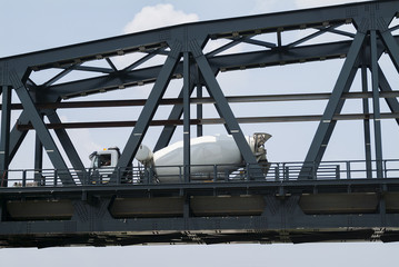 Cement mixer in transit on the metal bridge