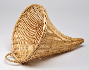 Empty wicker basket in the shape of cornucopia