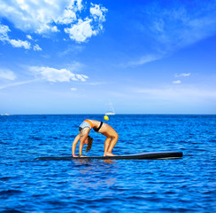 Yoga girl over SUP Stand up Surf board