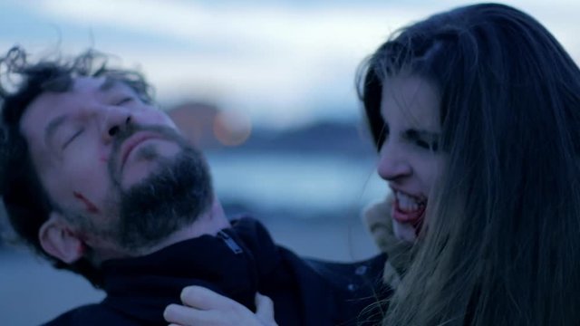 Man running away from angry female vampire slow motion closeup