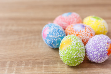 Artificial color eggs on wooden plank background. For Easter day use