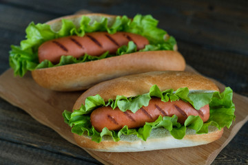 Hotdogs on a wooden board. Photo closeup.