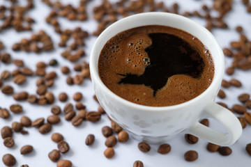 Cup of black coffee on the background of coffee bean