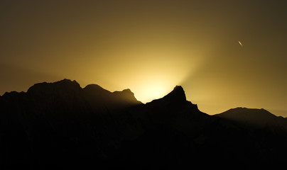 Beautiful yellow sunset over the mountains peak
