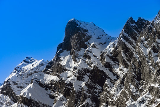 Beautiful snowy mountains, sunny day in Alps