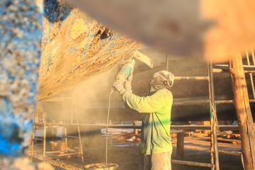 A man using grinder in preparation for anti foul paint being applied