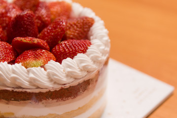 Strawberry Cake on wood background.