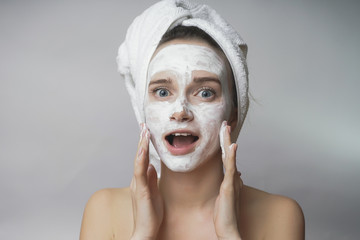 woman gets white mask on the face,applying scrub