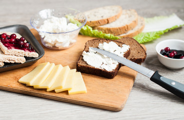 A sandwich with feta cheese and jam for breakfast. Concept for a bakery and healthy food. On a wooden background top view