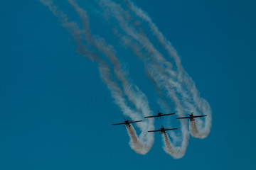 4 planes at airshow. Teamwork. Acrobat.