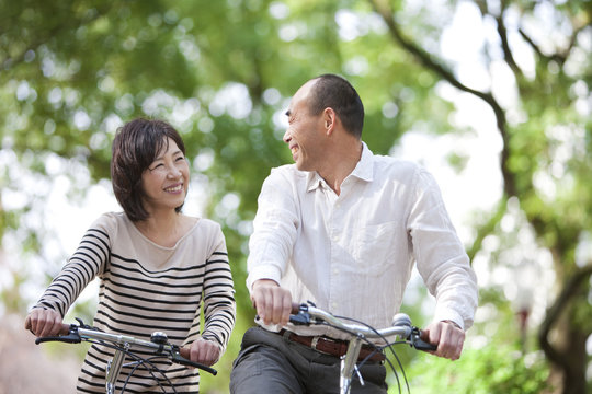 Mature couple riding bicycle