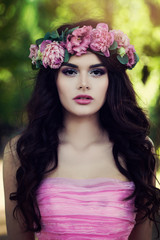 Perfect Brunette Model wearing Pink Dress with Flowers Outdoors