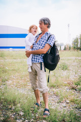 Family girl in the arms of his father outdoors.