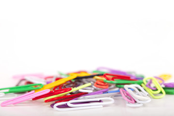 Pile of colorful paperclips isolated on a white background.