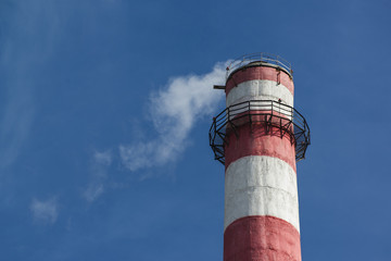 Pipe of an industrial plant against a blue sky