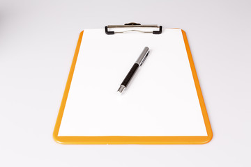 pen or pencil on empty paper in clipboard on white - business concept
