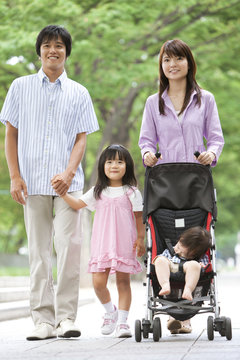 Family of Four Walking in Park