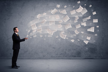 Caucasian businessman holding newspapers