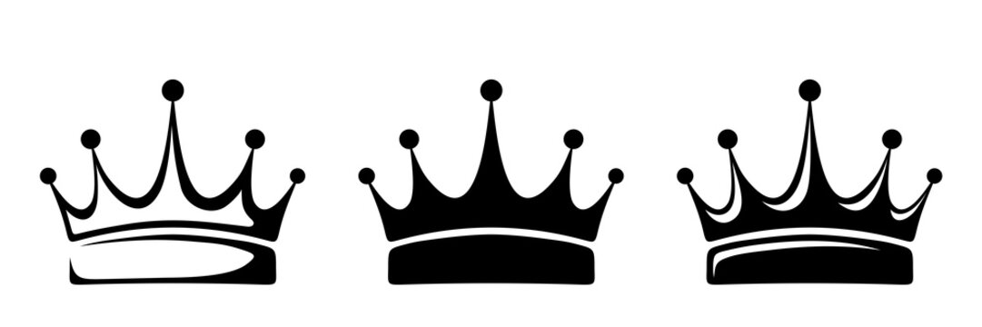 Set of three vector black silhouettes of crowns isolated on a white background.