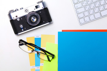 Top view of office graphic design pen mouse with laptop wireless mouse and vintage old camera on white table. Concept graphic design workplace