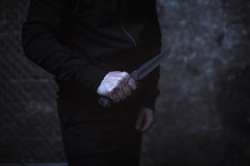 Classic street villain holding up a knife