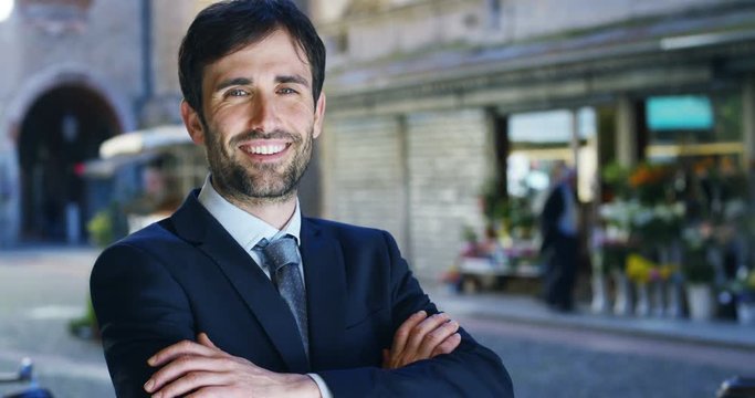 A man in a suit, looks in camera and smiles proud and sure of himself. Concept of politics, business, finance, banking, insurance and testimonials for political campaign.