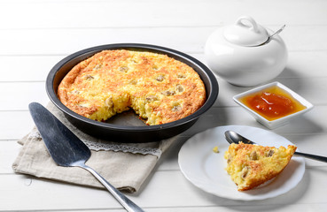 Slice of cheese casserole served with honey