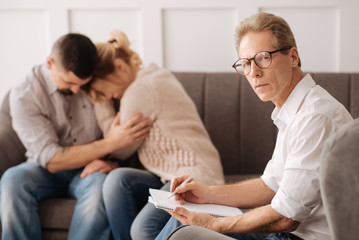 Fototapeta premium Serious confident therapist looking at you