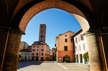 Piazza Risorgimento, main square of Alba (Piedmont, Italy) seen through the colonnade of Saint...