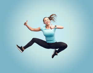 happy smiling sporty young woman jumping in air