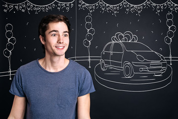 Cheerul smiling man standing near car