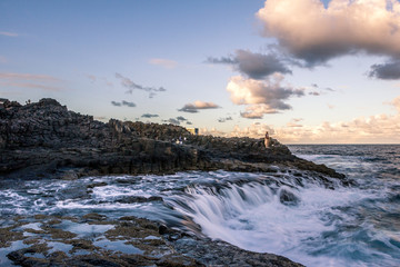 Angler at the stone coast while fishing