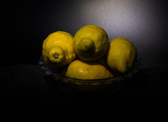 Still life lemons isolated on a dark black background