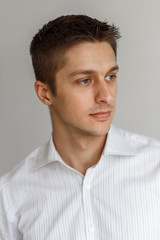 Fototapeta premium Portrait of a young man in a respectable white shirt