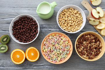 Obraz na płótnie Canvas prima colazione con cereali colorati e frutta su tavolo di cucina grigio