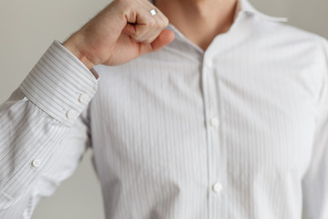 Sleeve of a white shirt. Buttons on Cuffs. close up view