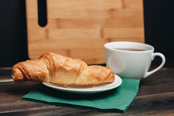  coffee mug tea on the table, croissant