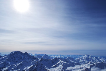 snow peaks, ridge, blue sky, floating clouds. beautiful view from ski slope.